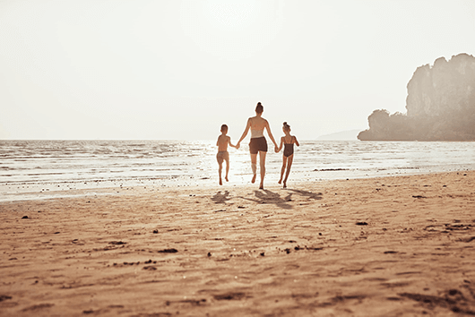 Family running on a beach summer fun with the kids